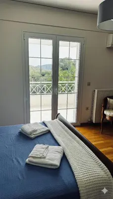 a bedroom with a bed with two towels on it at The Lotus House - Premium Coastal Living in Porto Rafti