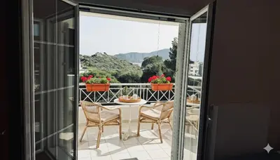 a table and chairs on a balcony with a view at The Lotus House - Premium Coastal Living in Porto Rafti