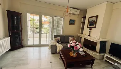 a living room with a couch and a fireplace at The Lotus House - Premium Coastal Living in Porto Rafti