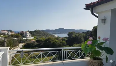 a balcony with a view of the water at The Lotus House - Premium Coastal Living in Porto Rafti