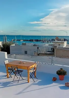 a wooden table and two chairs on top of a roof at The Fisherman's Romance in Piraeus