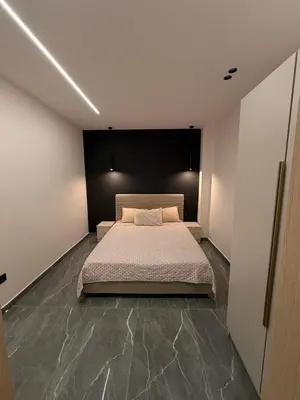 a bedroom with a bed and a black wall at Monda Apartment 3 in Piraeus