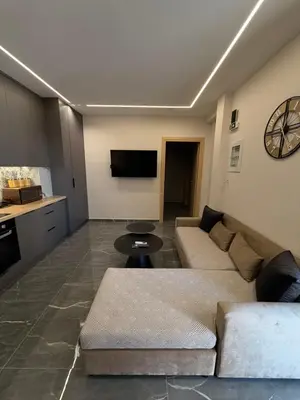 a living room with a couch and a tv at Monda Apartment 3 in Piraeus