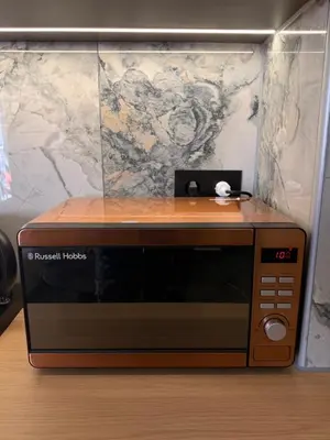 a microwave oven sitting on top of a table at Monda Apartment 3 in Piraeus