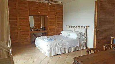 a bedroom with a bed and a table in it at Villa Horizon Bleau by A&D Properties in Sounio