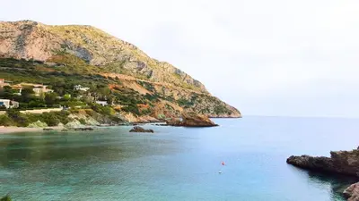 a large body of water next to a mountain at Villa Horizon Bleau by A&D Properties in Sounio