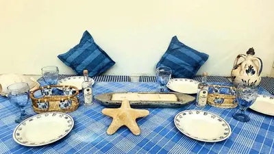 a blue and white table with plates and a starfish at Villa Horizon Bleau by A&D Properties in Sounio