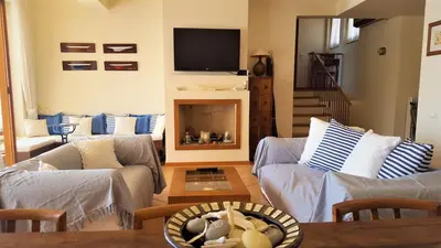 a living room with two couches and a tv at Villa Horizon Bleau by A&D Properties in Sounio