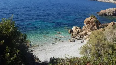 a beach with people swimming in the water at Villa Horizon Bleau by A&D Properties in Sounio