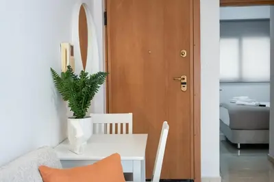 a living room with a table and a potted plant at Elysian Lycabettus-Resilience in Athens