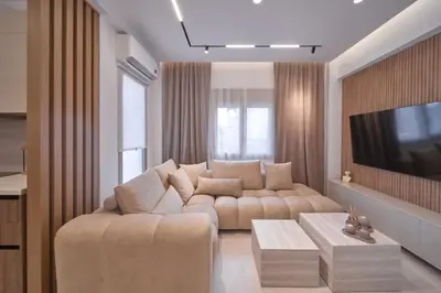 a living room with a couch and a tv at SOLUNA Hideaway Athens - Luxury Jacuzzi Suite in Athens