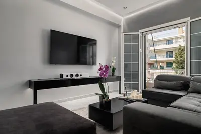 a living room with a couch and a piano at Eclipse Asklipion Voula in Athens