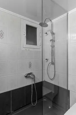 a bathroom with a shower with a glass door at Eclipse Asklipion Voula in Athens