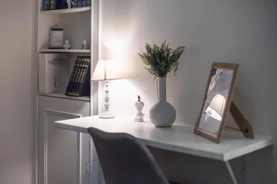a white table with a vase and a picture and a lamp at Athena House Elegant Stay For Families By Greece Apartments in Athens
