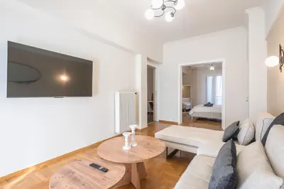 a living room with a couch and a table at Athena House Elegant Stay For Families By Greece Apartments in Athens