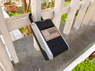 a cell phone hanging off the side of a bench at Sunlit Retreat in Voula Center in Athens