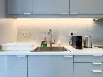 a kitchen counter with a sink and a counter top at Sunlit Retreat in Voula Center in Athens