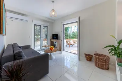 a living room with a couch and a table at 2b apartment beyond a house Glyfada center in Athens