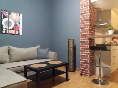 a living room with a couch and a table at Apartments in Pereas in an ideal location in Piraeus