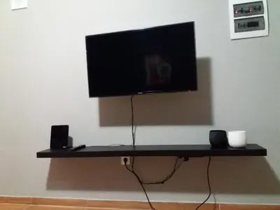 a flat screen tv sitting on top of a shelf at Apartments in Pereas in an ideal location in Piraeus