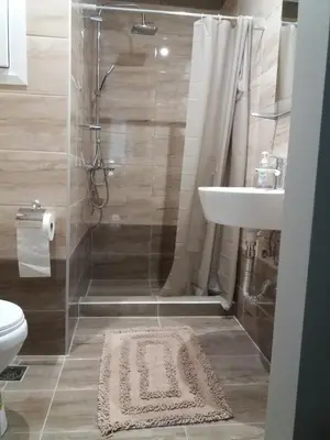 a bathroom with a shower and a toilet and a sink at Apartments in Pereas in an ideal location in Piraeus