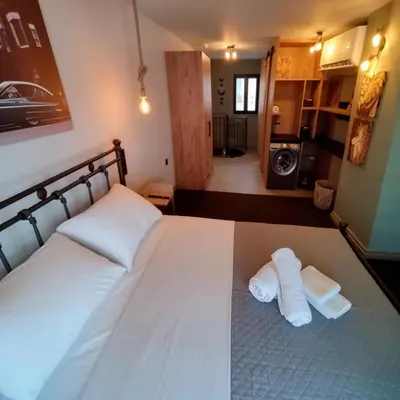 a bedroom with a bed with two towels on it at Cozy Split-Level Loft by Piraeus Port in Piraeus