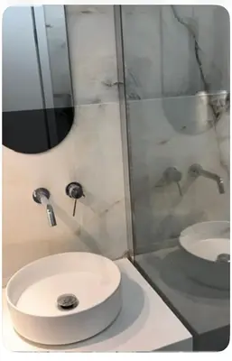 a bathroom with a white sink and a shower at Spacious 2-Bedroom Apartment in Paleo Faliro, Athens in Athens