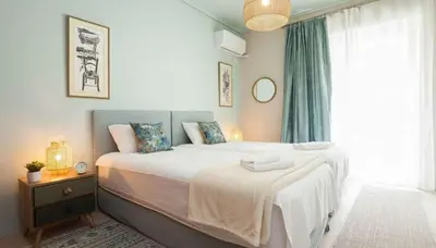 a bedroom with a large bed and a window at Premium 2 Bd Blue Retreat in Kallithea in Athens