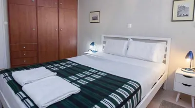 a bedroom with a large bed with two towels on it at Premium 2 Bd Blue Retreat in Kallithea in Athens