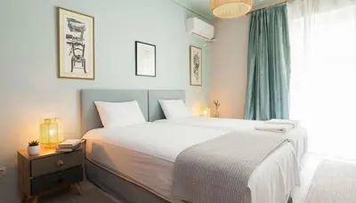 a bedroom with a large white bed and a window at Premium 2 Bd Blue Retreat in Kallithea in Athens