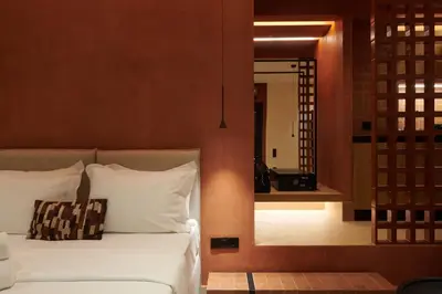 a bedroom with a bed with white pillows and a mirror at V13 Boho Suite in Athens
