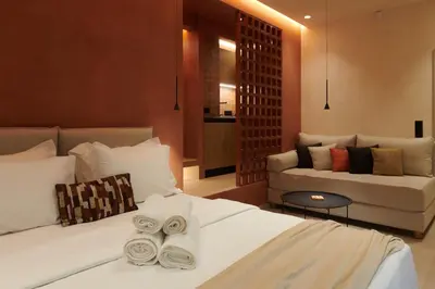 a hotel room with two beds and a couch at V13 Boho Suite in Athens