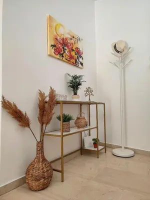 a room with a shelf with plants and a lamp at Feels like home in Athens center in Athens