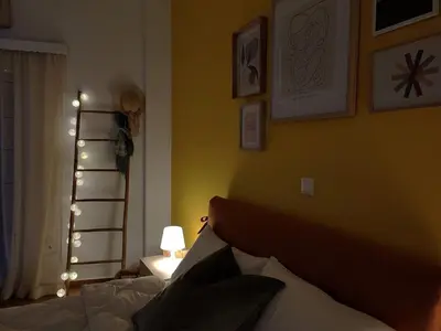 a bedroom with a bed and a yellow wall at Feels like home in Athens center in Athens