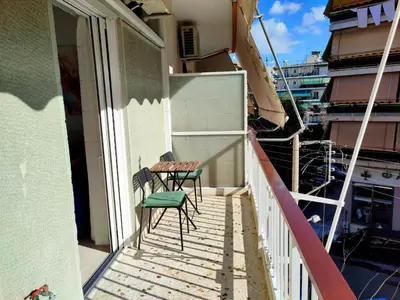 a balcony with two chairs and a table at Feels like home in Athens center in Athens