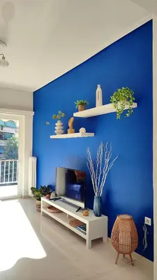 a living room with a blue wall with a tv at Feels like home in Athens center in Athens