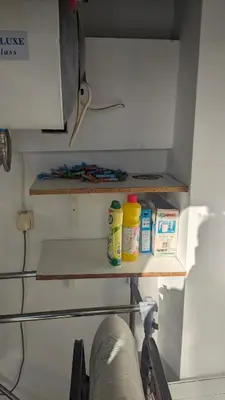 a shelf in a kitchen with some items on it at Cozy loft in the western suburbs of Athens! in Athens
