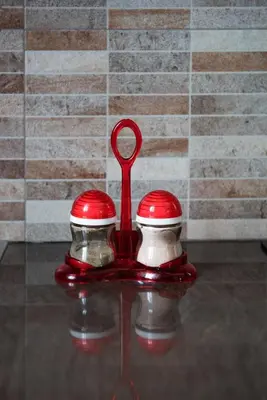a pair of red feeding utensils sitting on a table at Cozy loft in the western suburbs of Athens! in Athens