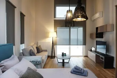 a living room with a bed and a couch at Athenean Rooftop Nest in Athens