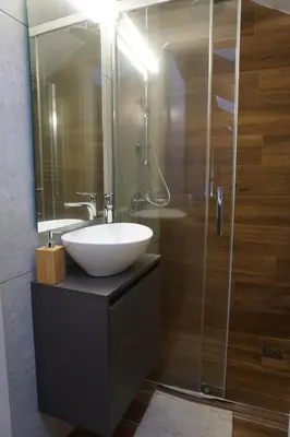 a bathroom with a white sink and a shower at Athenean Rooftop Nest in Athens