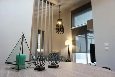 a dining table with two metal objects on top of it at Athenean Rooftop Nest in Athens
