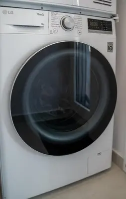 a white washing machine with a black door at Villa Oneiron in Anavissos