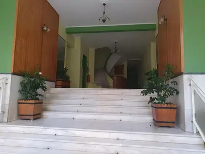 a building with stairs and potted plants on it at Cosy executive room in beautiful n quiet flat in Athens