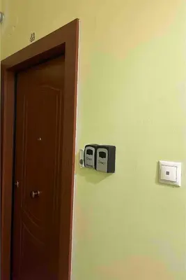 a room with a door and a clock on the wall at Cosy executive room in beautiful n quiet flat in Athens