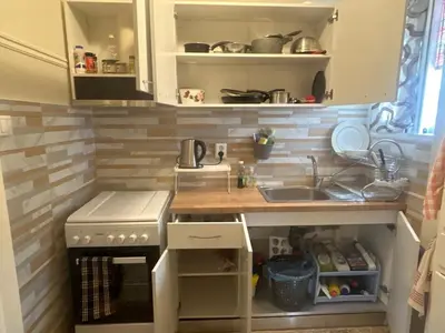 a small kitchen with a sink and a stove at Cosy executive room in beautiful n quiet flat in Athens