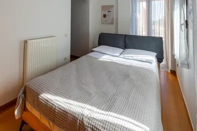 a large bed in a room with a window at Villa Elysia in Porto Rafti