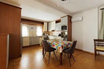 a kitchen and dining room with a table and chairs at Villa Elysia in Porto Rafti