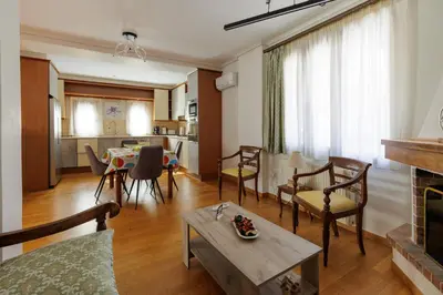 a living room with a couch and a table at Villa Elysia in Porto Rafti