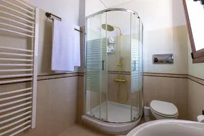 a bathroom with a shower and a toilet at Villa Elysia in Porto Rafti