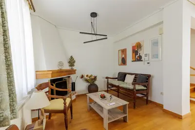 a living room with a table and chairs at Villa Elysia in Porto Rafti